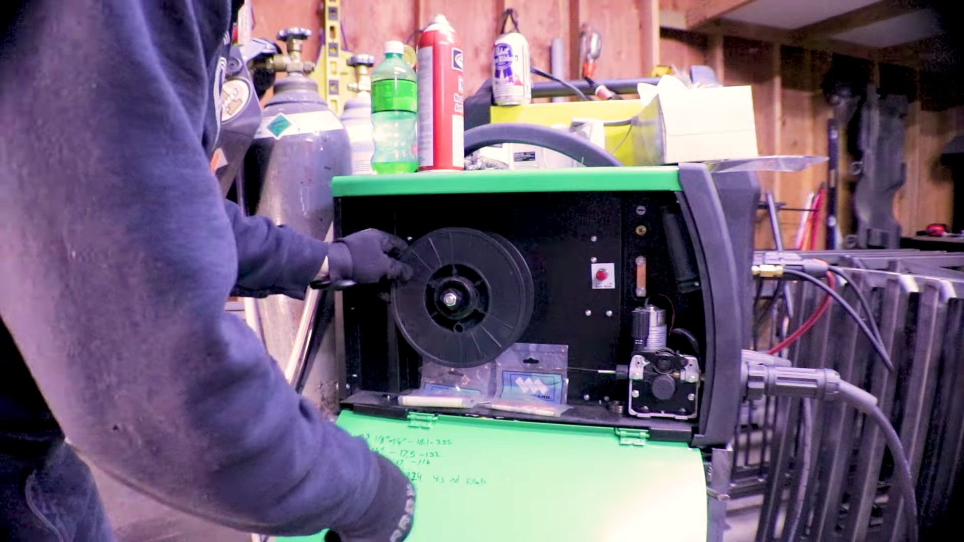 MIG wire spool installation showing wire feed system and consumable tracking