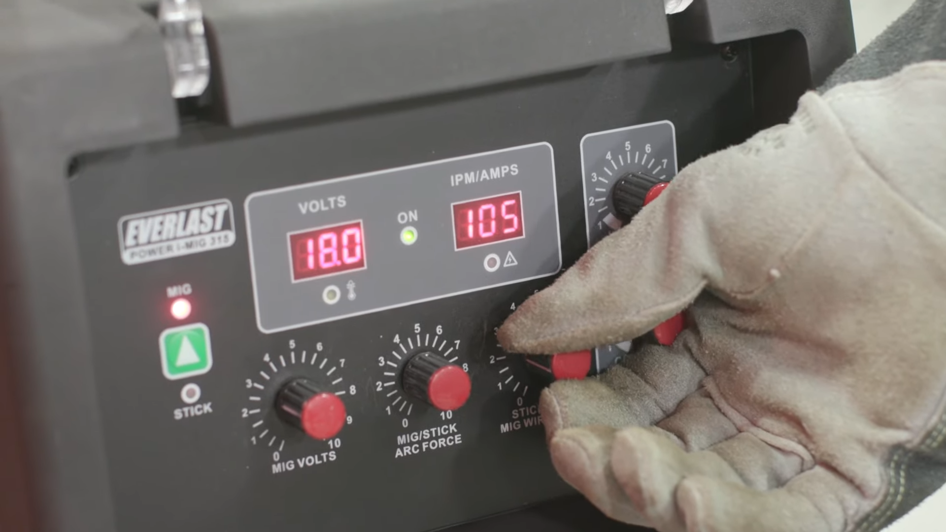 MIG welder control panel showing wire speed and voltage dials