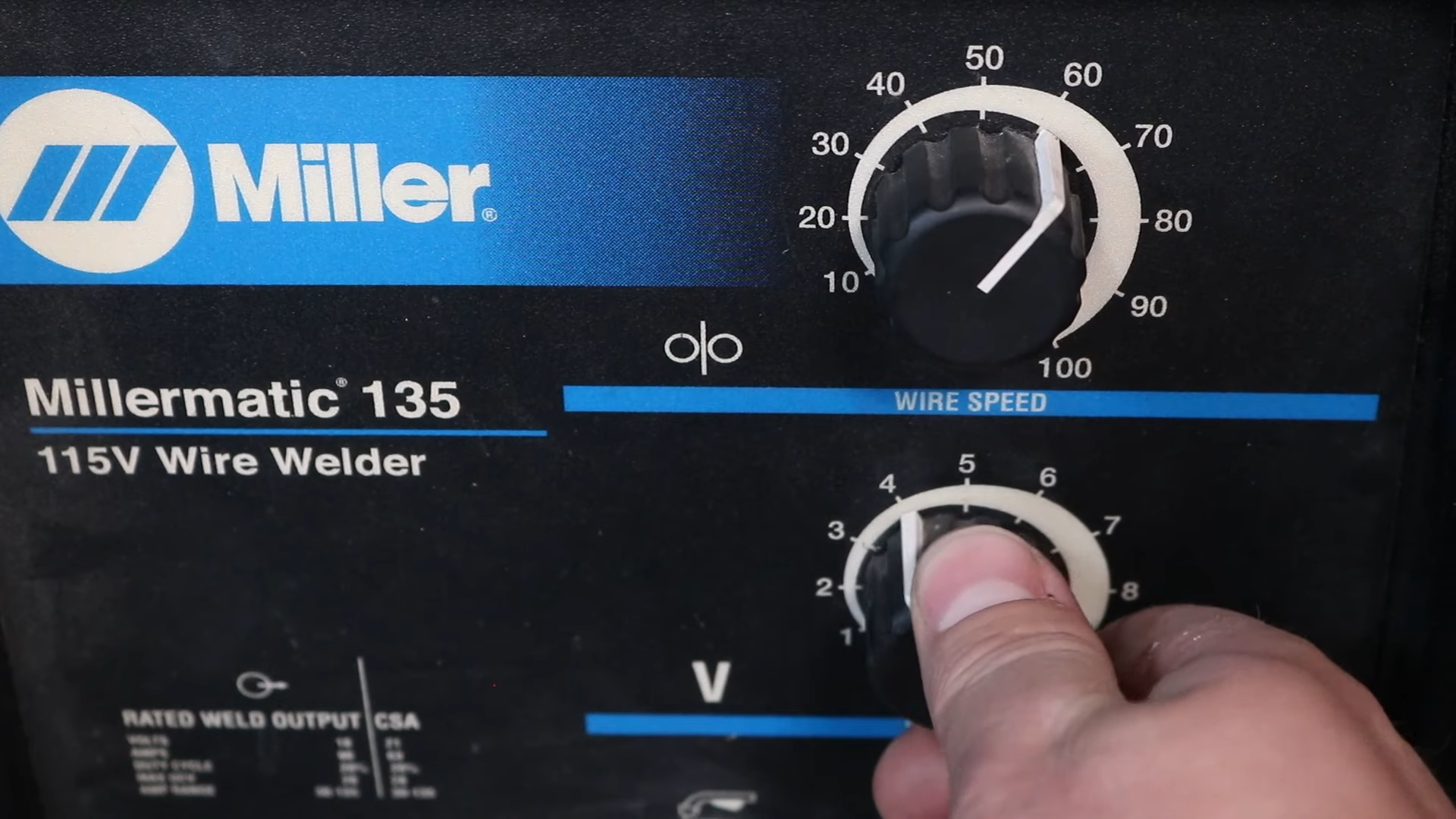 MIG welder control panel showing wire speed and voltage settings