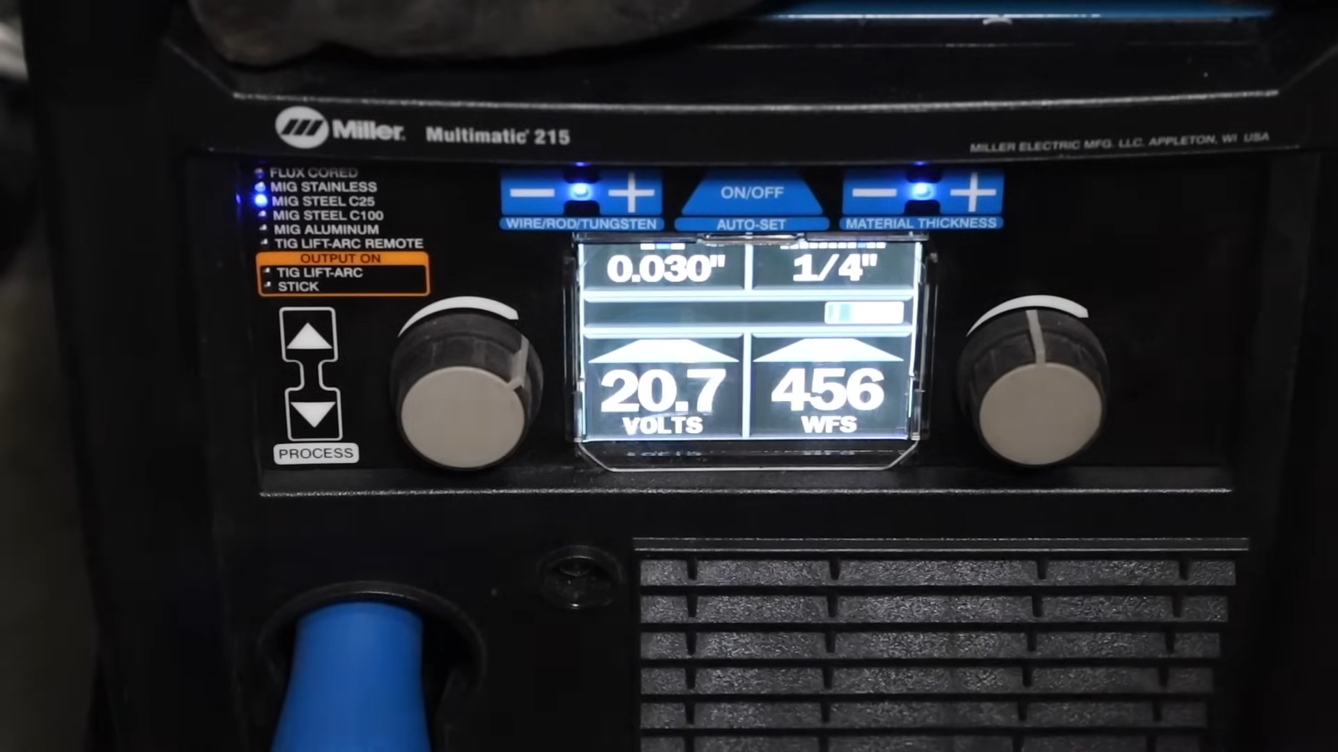 MIG welder control panel showing amperage settings for different wire sizes