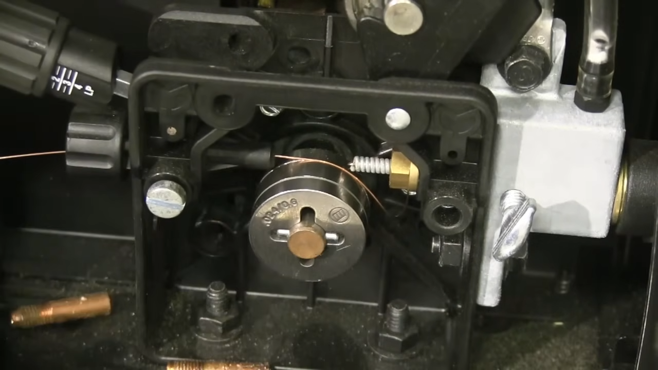 MIG welder in action showing proper arc and wire feeding through contact tip