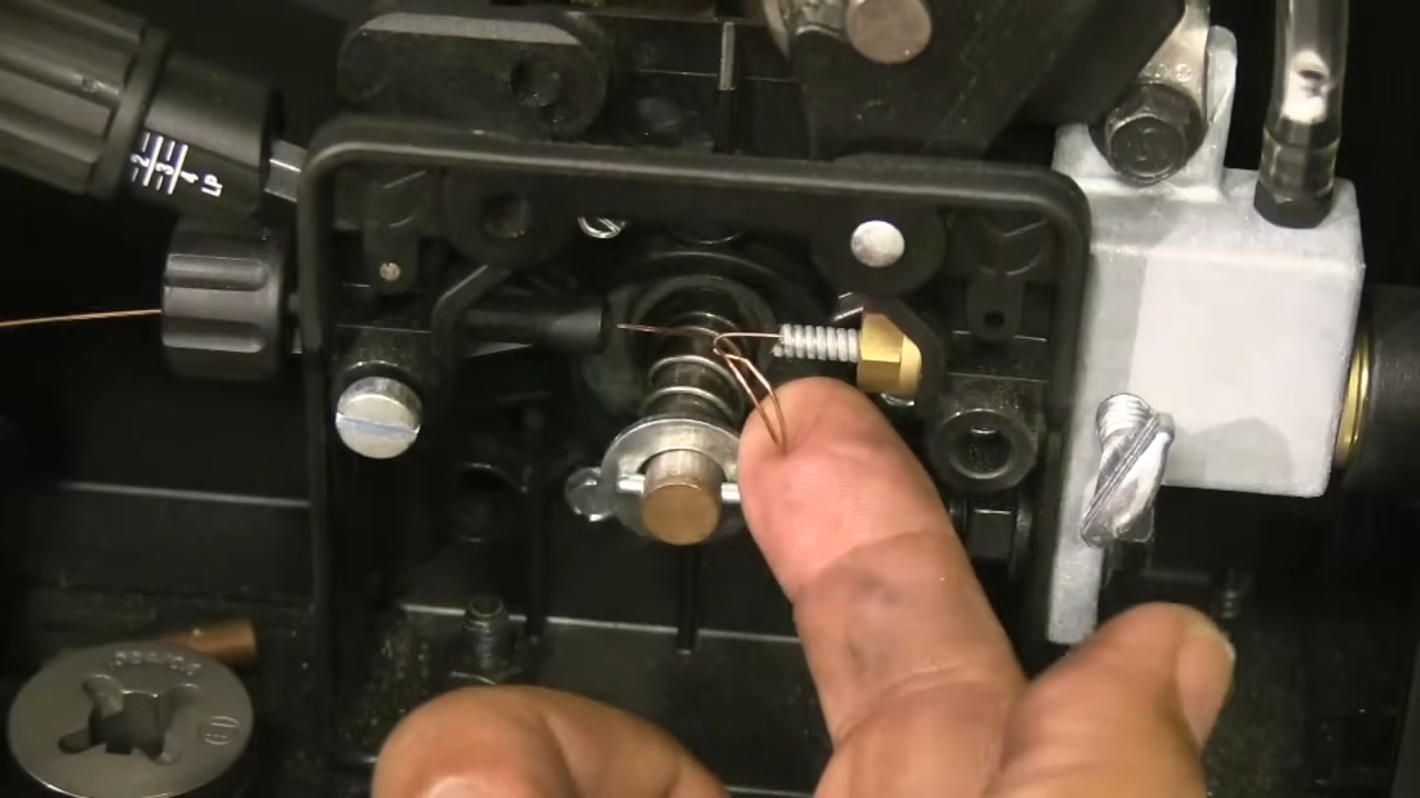 Close-up of MIG welder control panel showing wire feed speed dial and voltage settings