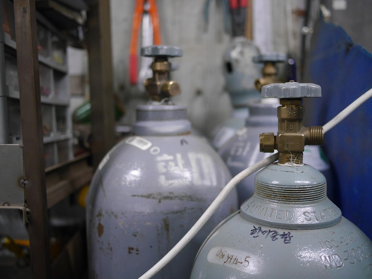 Industrial gas supply system for welding showing proper gas flow management and cylinder storage in fabrication shop
