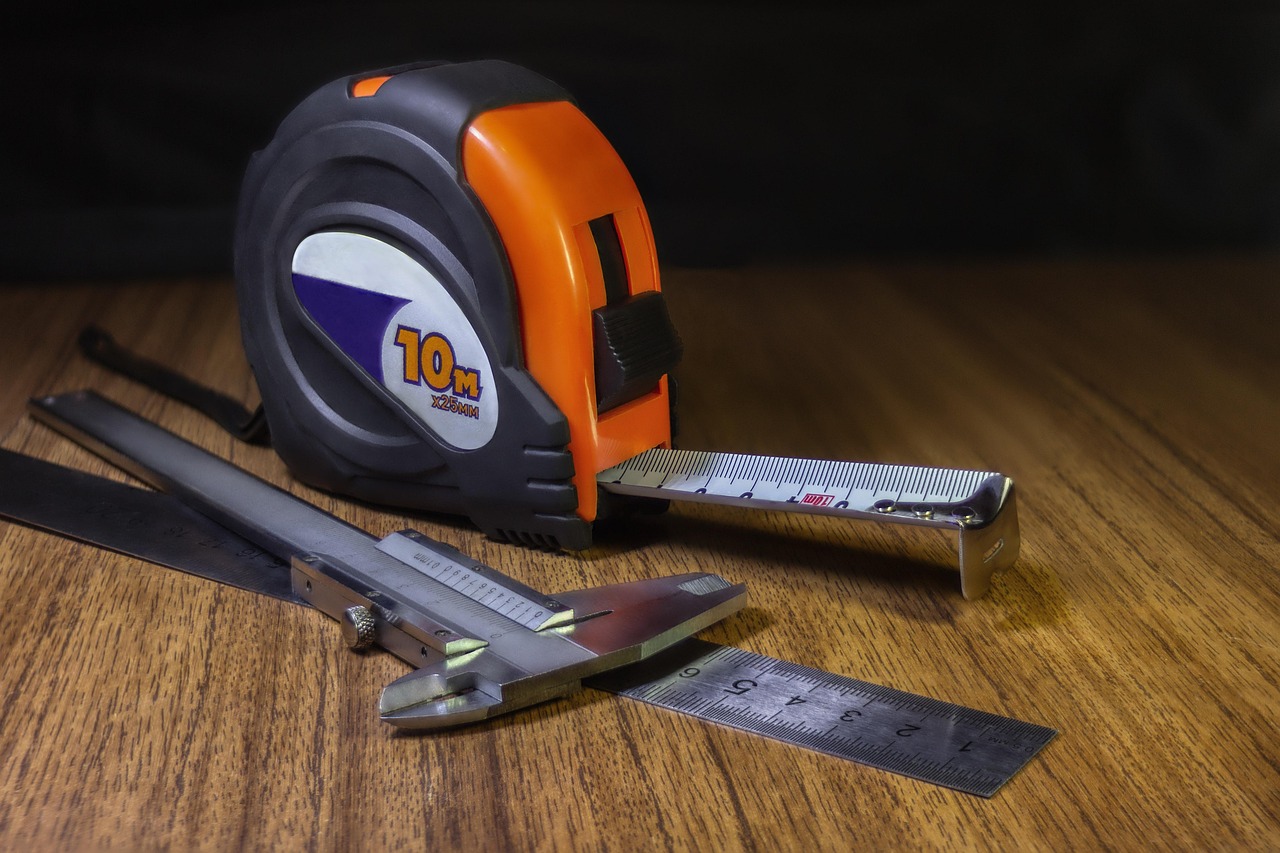 Measuring tools including ruler, tape measure and calipers for precise weld measurement