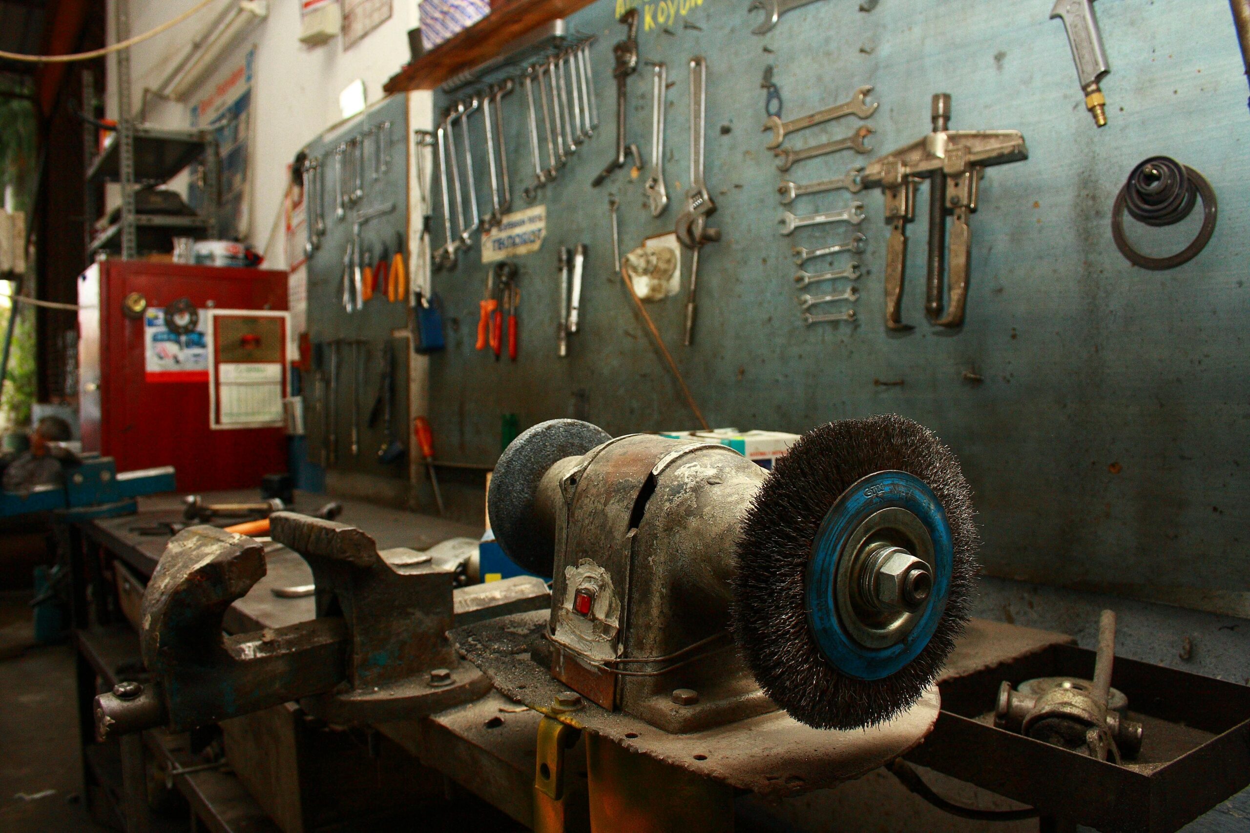 Benchtop with wire wheel and welding tools showing shop organization for material management