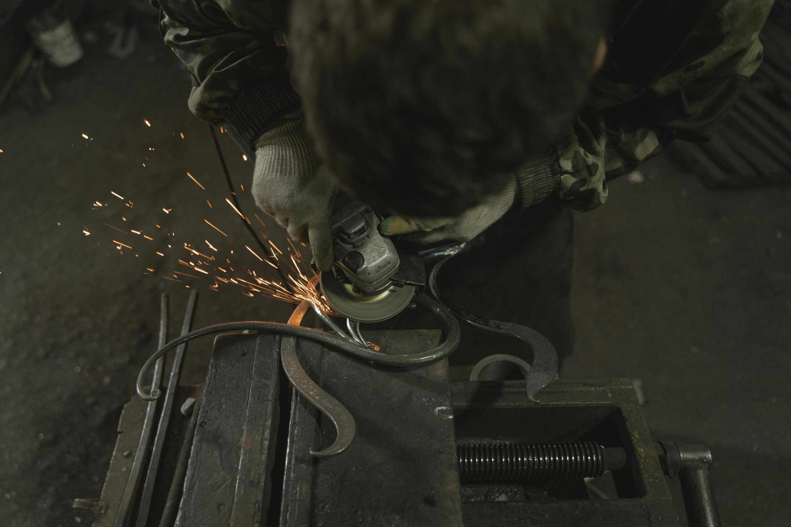 Fabricator welding custom metal project showing labor and skill involved in job estimation