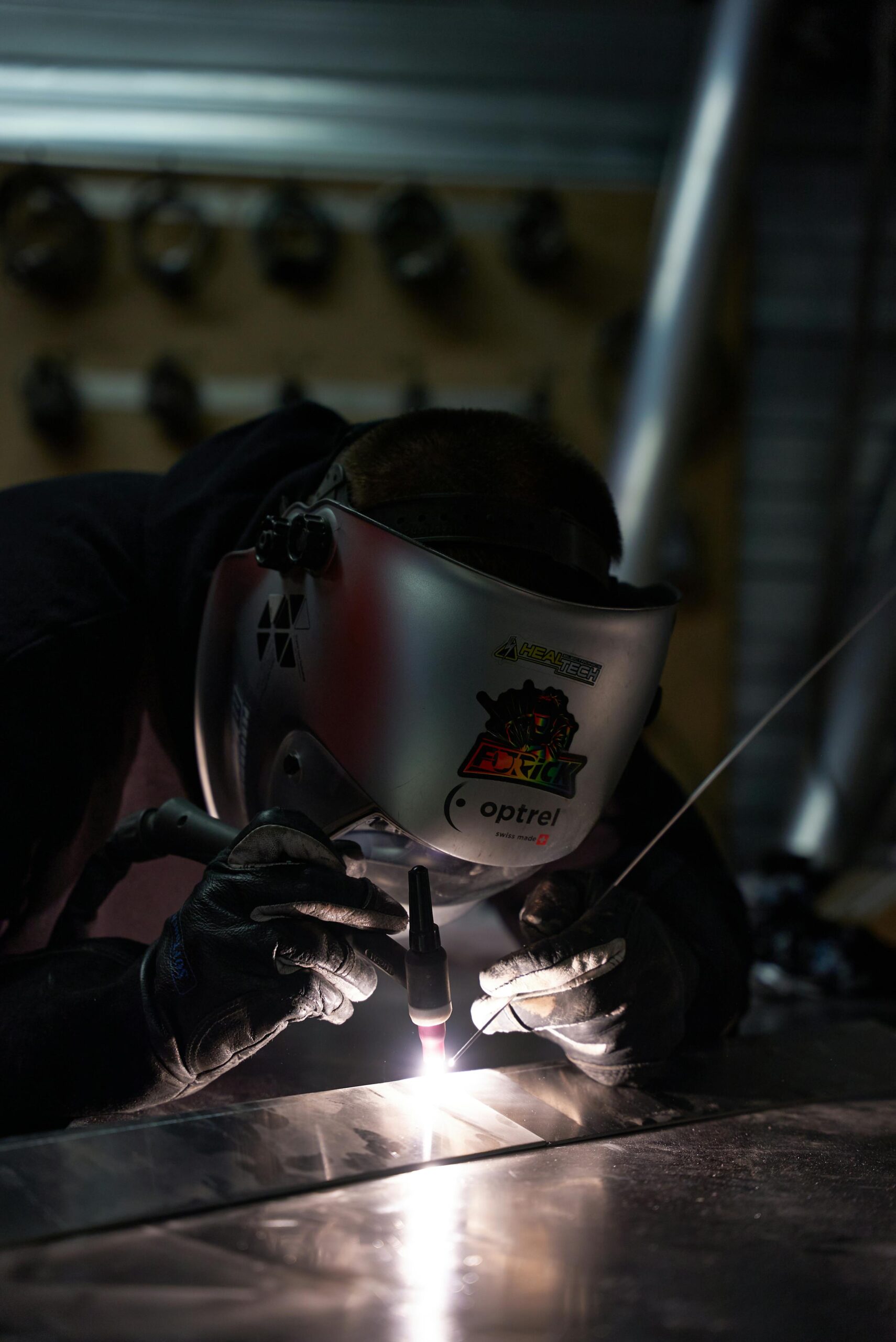 Welder performing field work on site showing mobile welding service and field rate considerations
