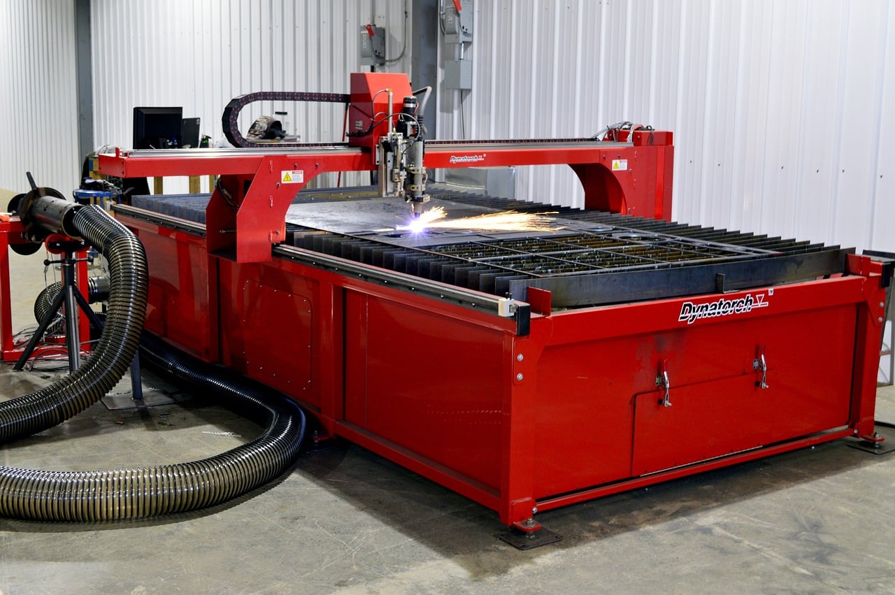 Industrial plasma cutting machine showing clean cut through thick steel plate with proper settings