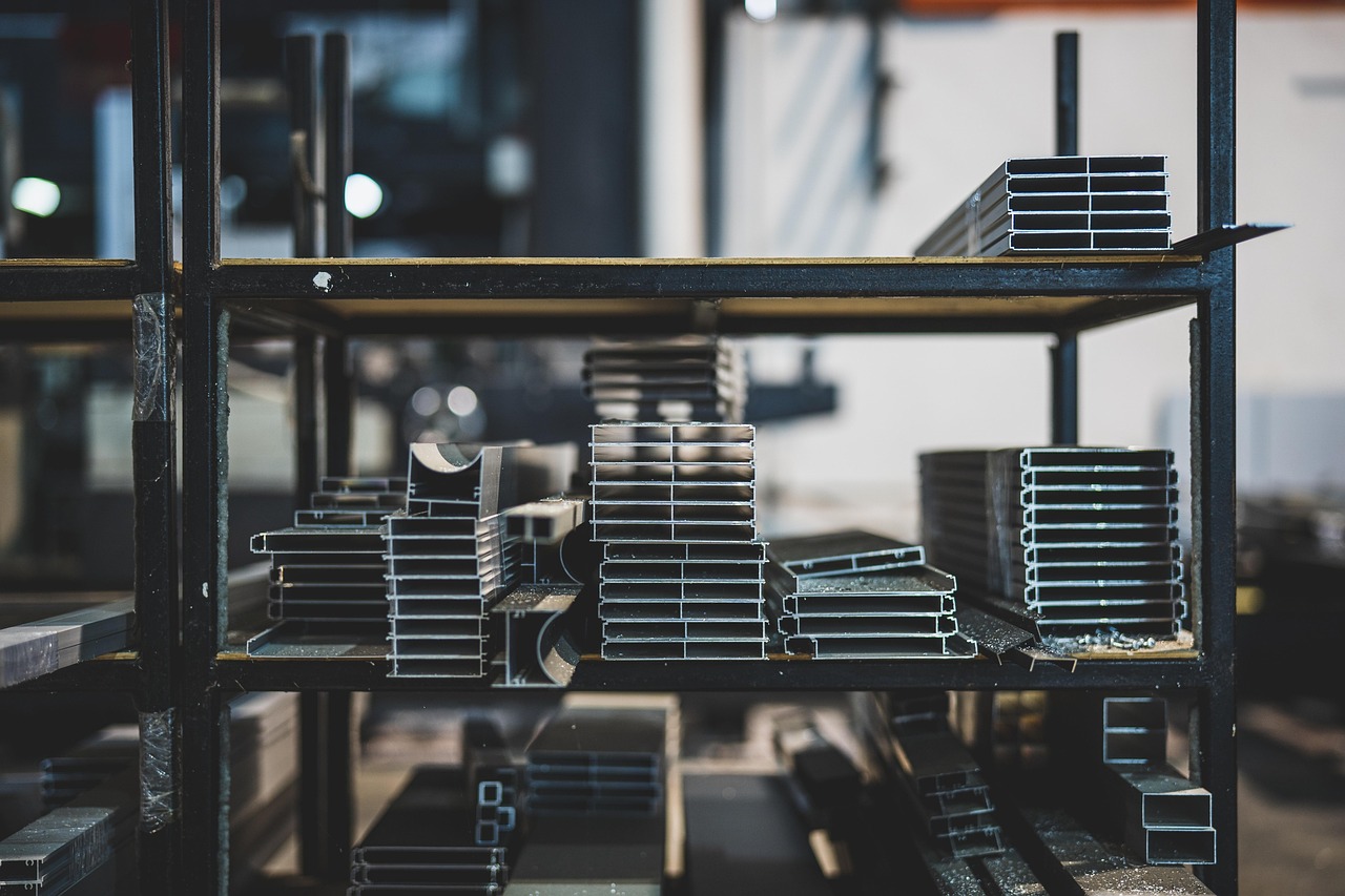 Metal warehouse storage showing square and rectangular steel tubing inventory for fabrication projects