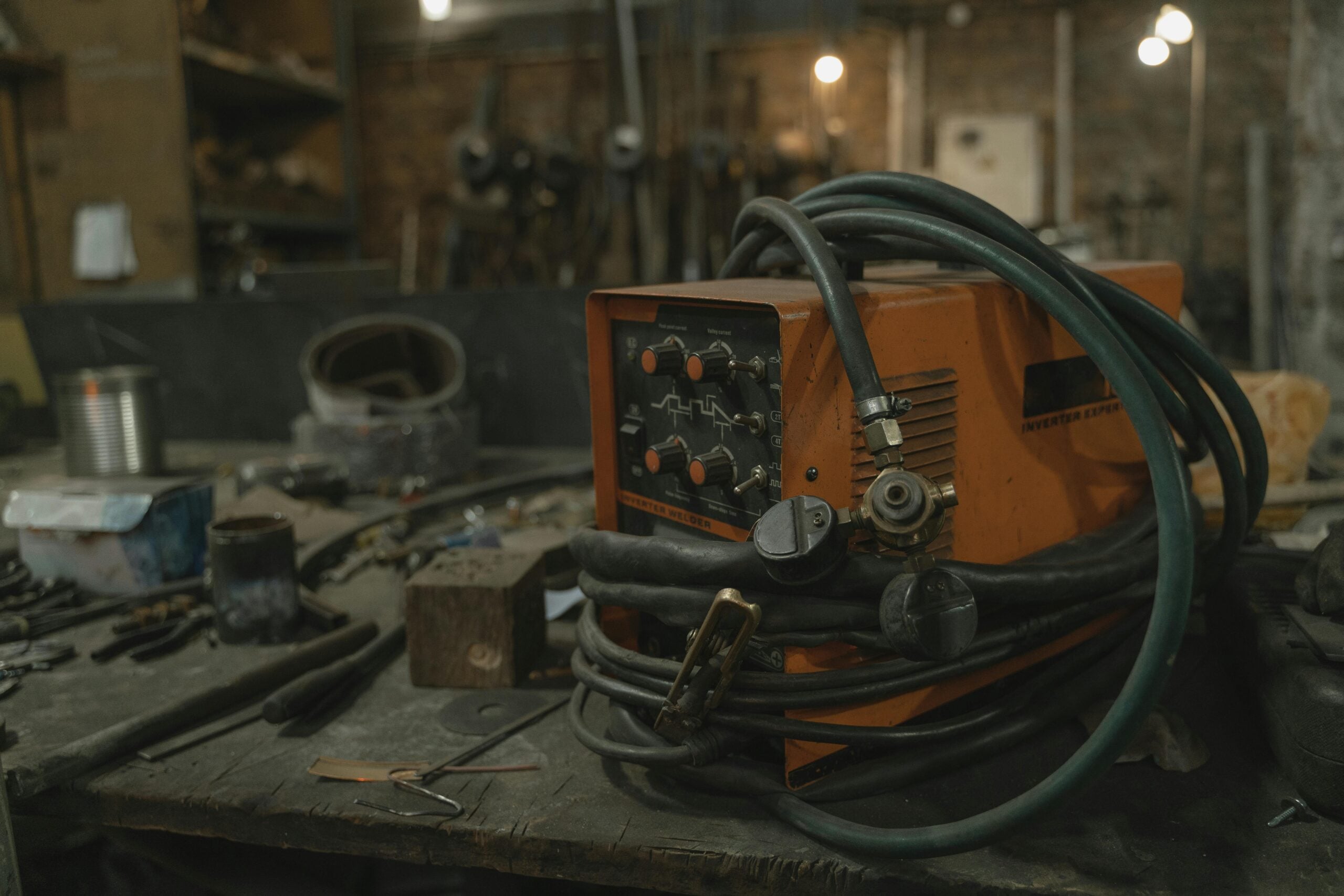 MIG welding setup showing welder machine and wire spool configuration